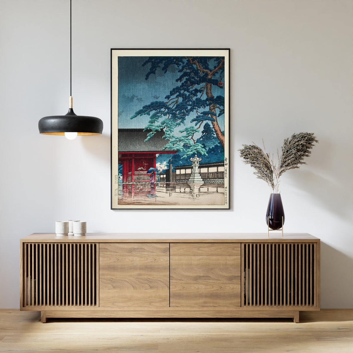Framed art print of Spring Rain at Gokokuji Temple by Kawase Hasui, above a slatted wood sideboard