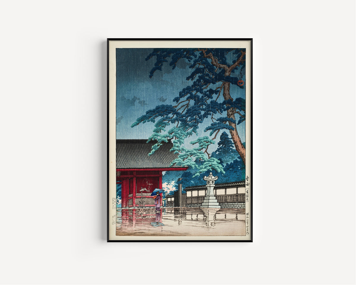 Framed art print of Spring Rain at Gokokuji Temple by Kawase Hasui, in a slim black frame on a plain white wall