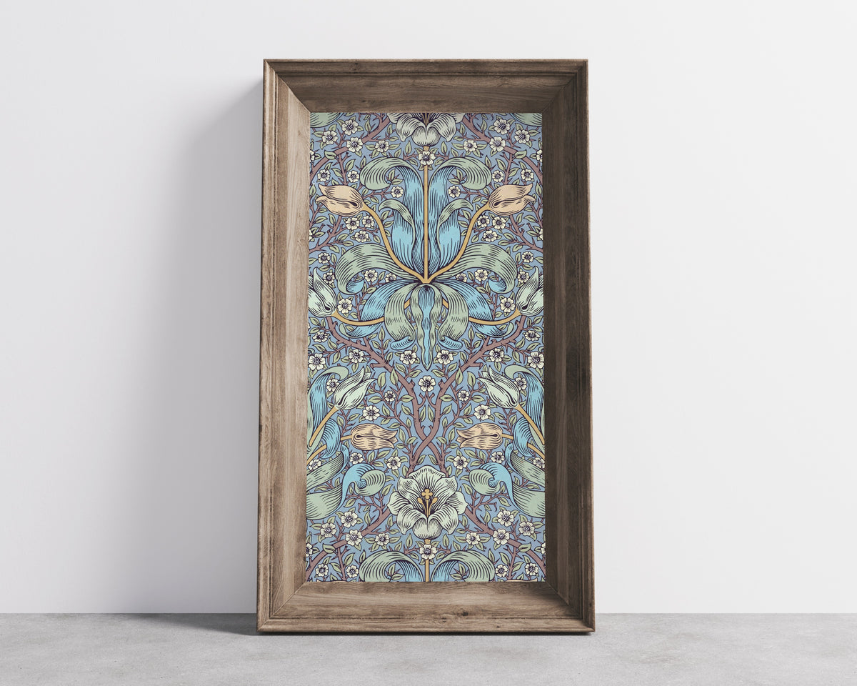 Framed art print of Spring Thicket by William Morris, in a wide wooden frame leaning against a concrete wall