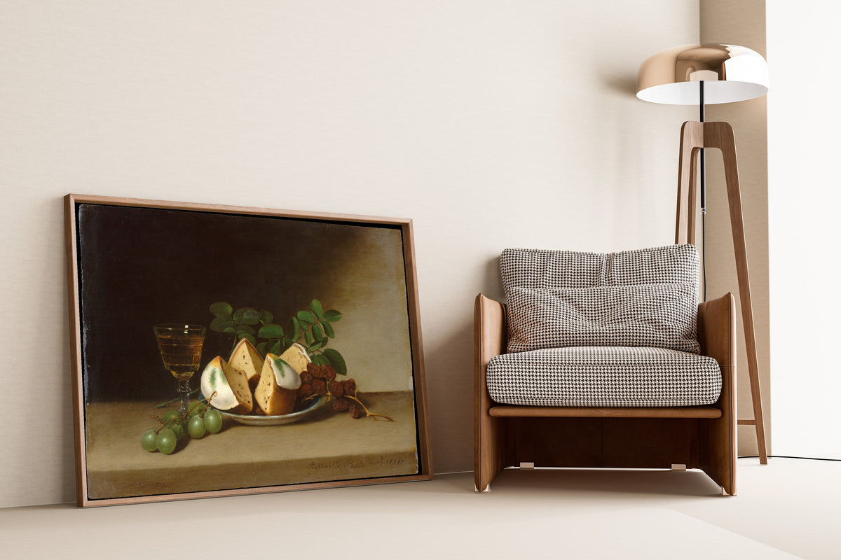 Still Life with Cake by Raphaelle Peale — framed and leaning against a wall beside an armchair and a floor lamp