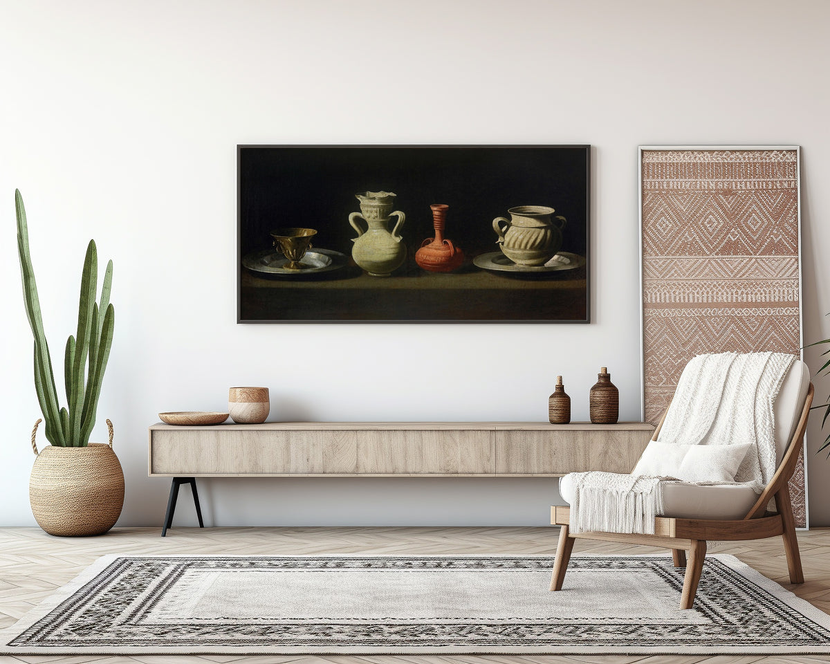 Framed art print of Still Life with Vessels by Francisco de Zurbarán, above a sideboard in a living room