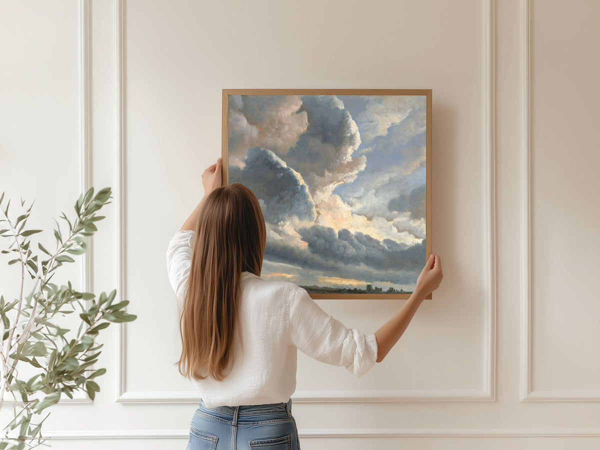 Study of Clouds with a Sunset near Rome by Simon Denis — being hung, framed, on a panelled wall