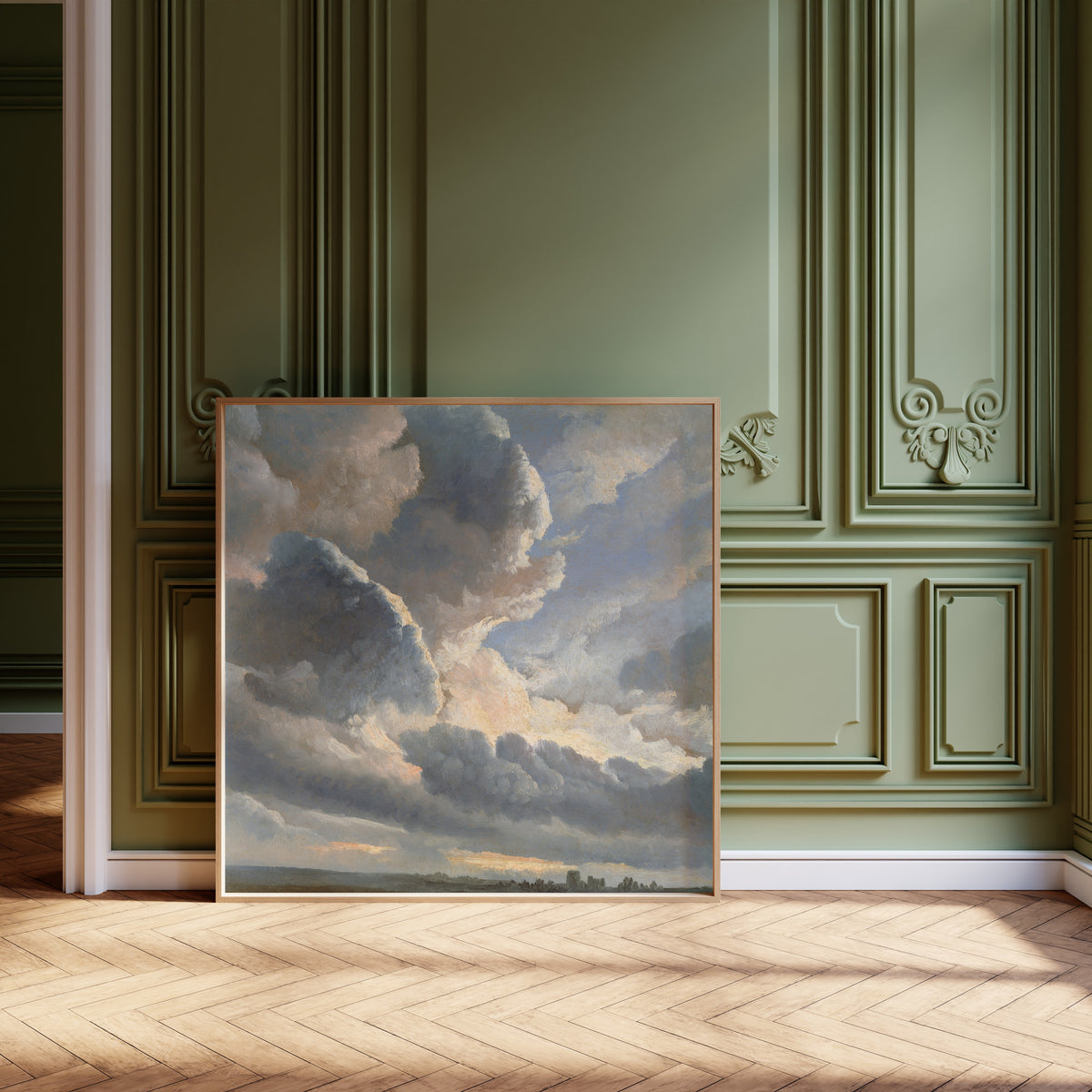 Study of Clouds with a Sunset near Rome by Simon Denis — framed and leaning against olive-green panelling on a herringbone floor