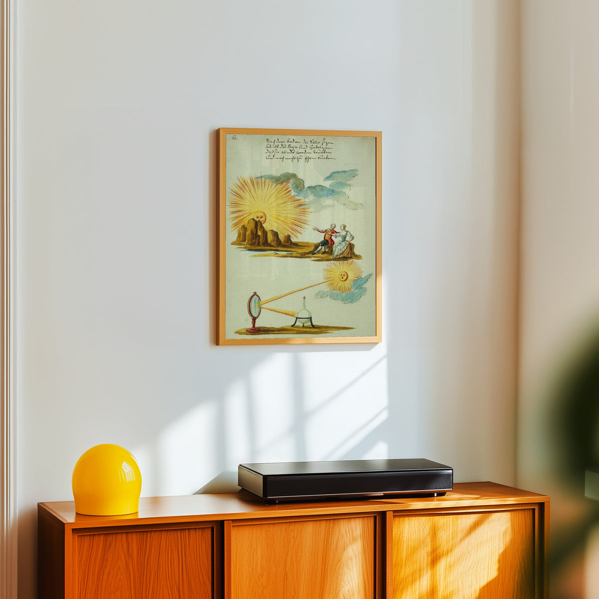 Framed art print of Sunlight Focused by a Mirror on an Alchemical… by Thesaurus Thesaurorum, in a light wood frame on a white wall above an orange sideboard