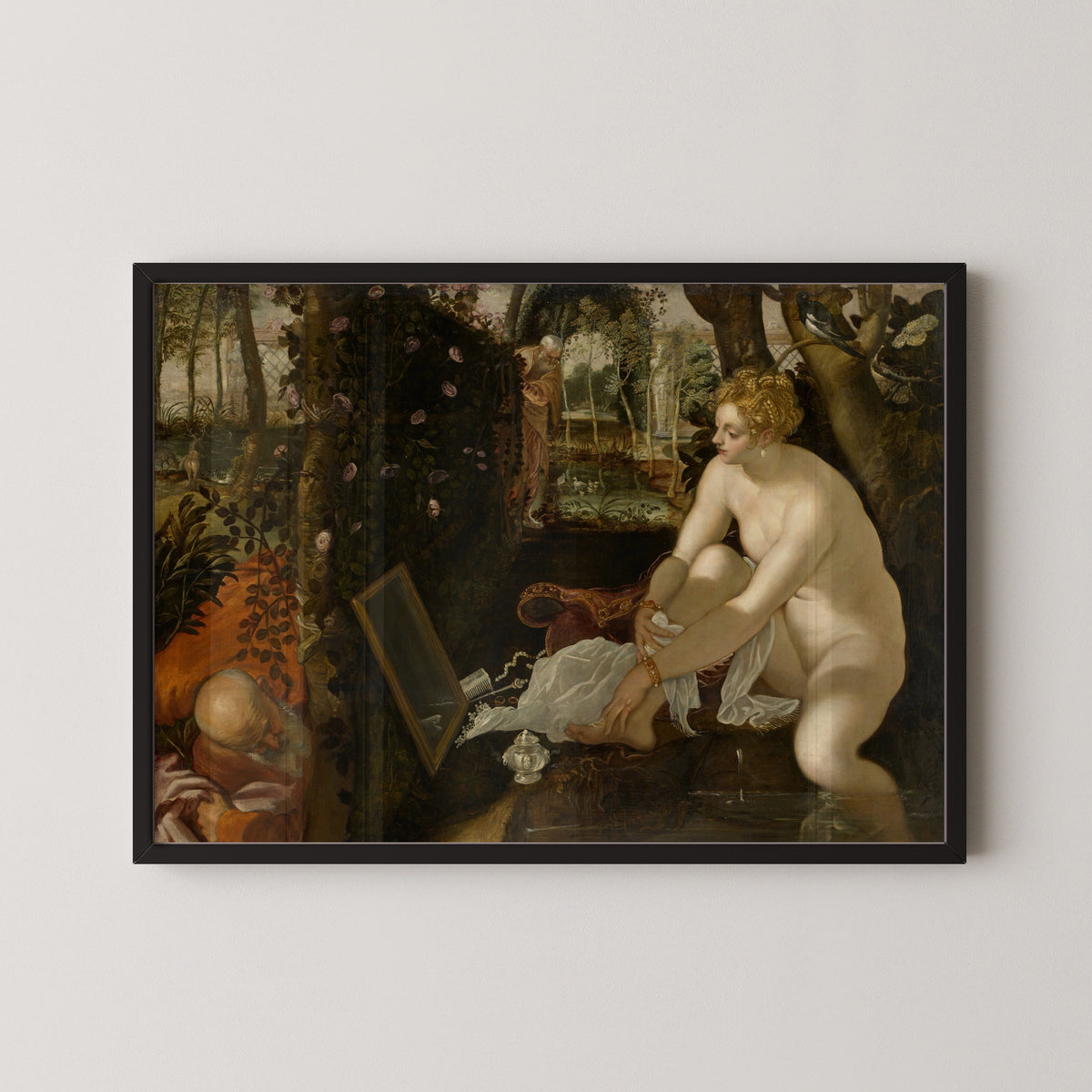 Framed art print of Susanna and the Elders by Tintoretto, in a black frame on a pale wall