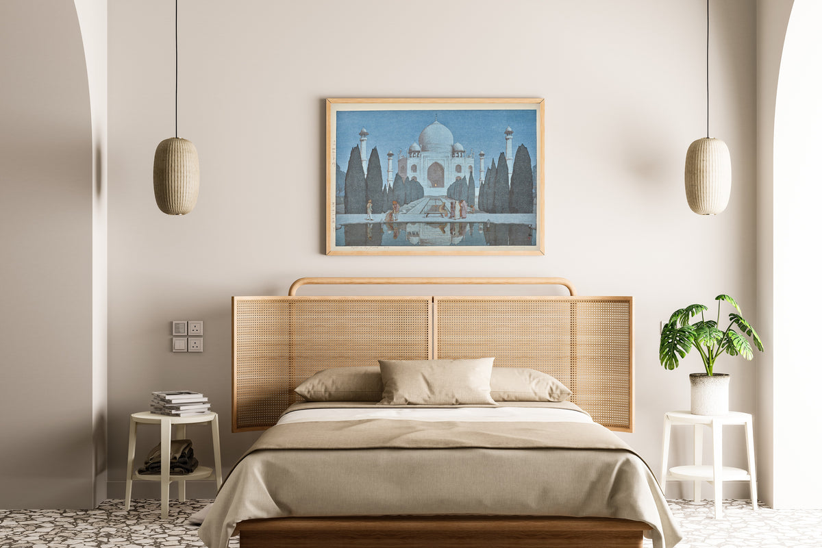 Framed art print of Taj Mahal at Night, No. 6 by Hiroshi Yoshida, above a cane-headboard bed