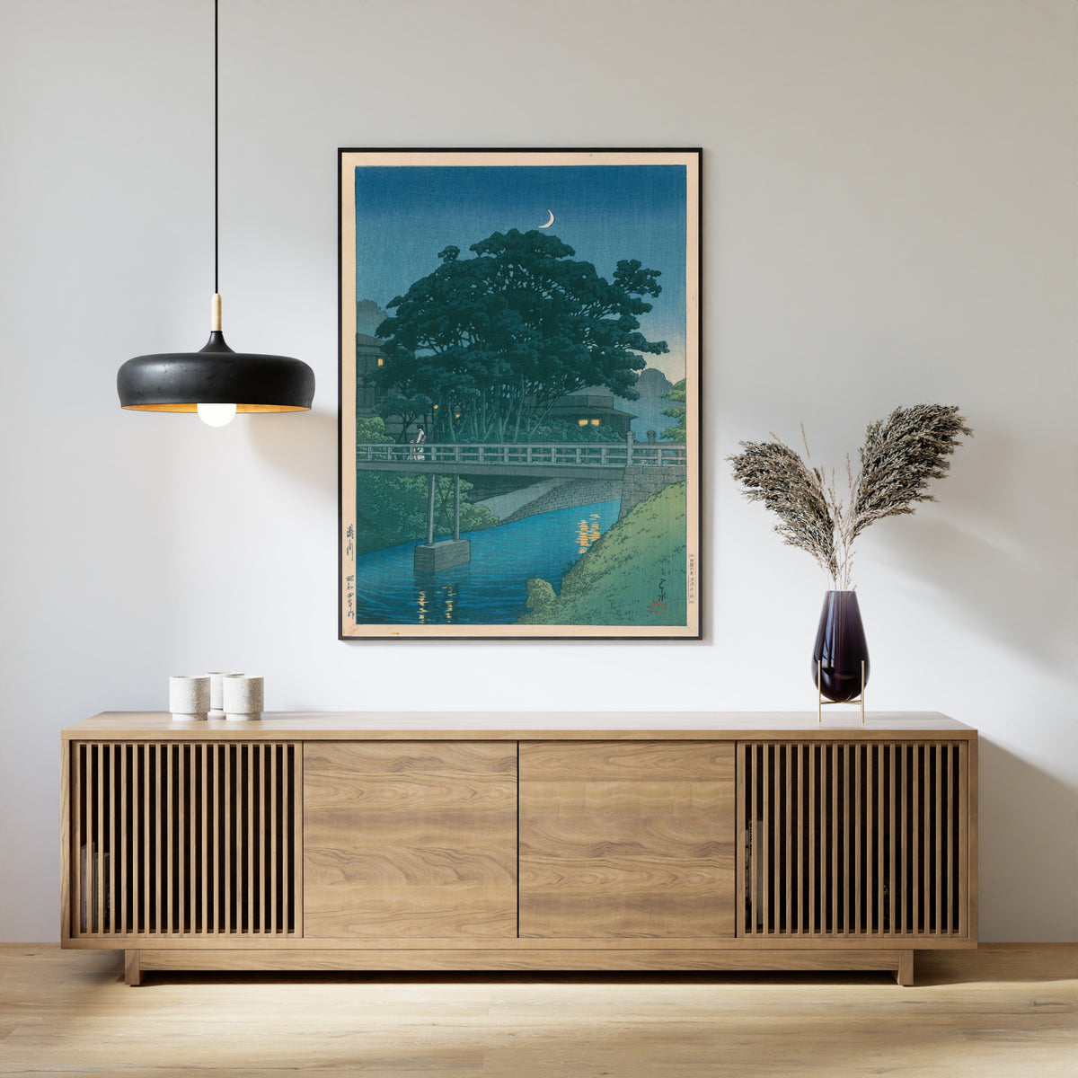 Framed art print of Takinogawa River by Kawase Hasui, above a slatted wood sideboard