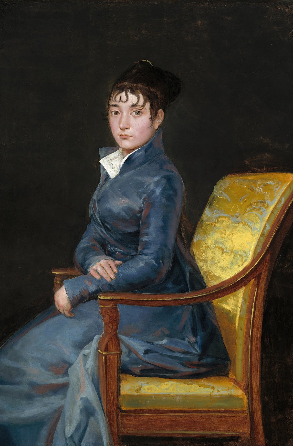 Thérèse Louise de Sureda by Francisco de Goya — A young woman in slate blue sits in a yellow damask armchair