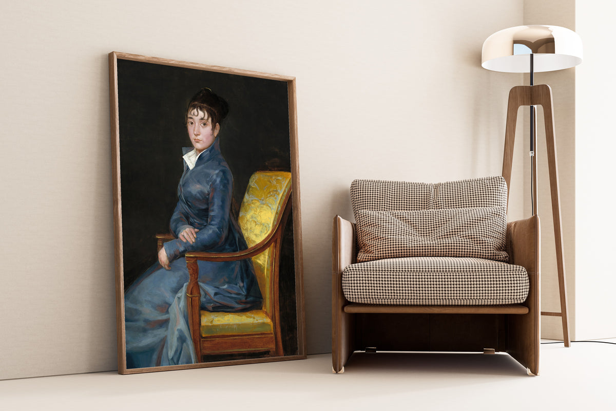 Framed art print of Thérèse Louise de Sureda by Francisco de Goya, leaning against a wall beside an armchair and a floor lamp