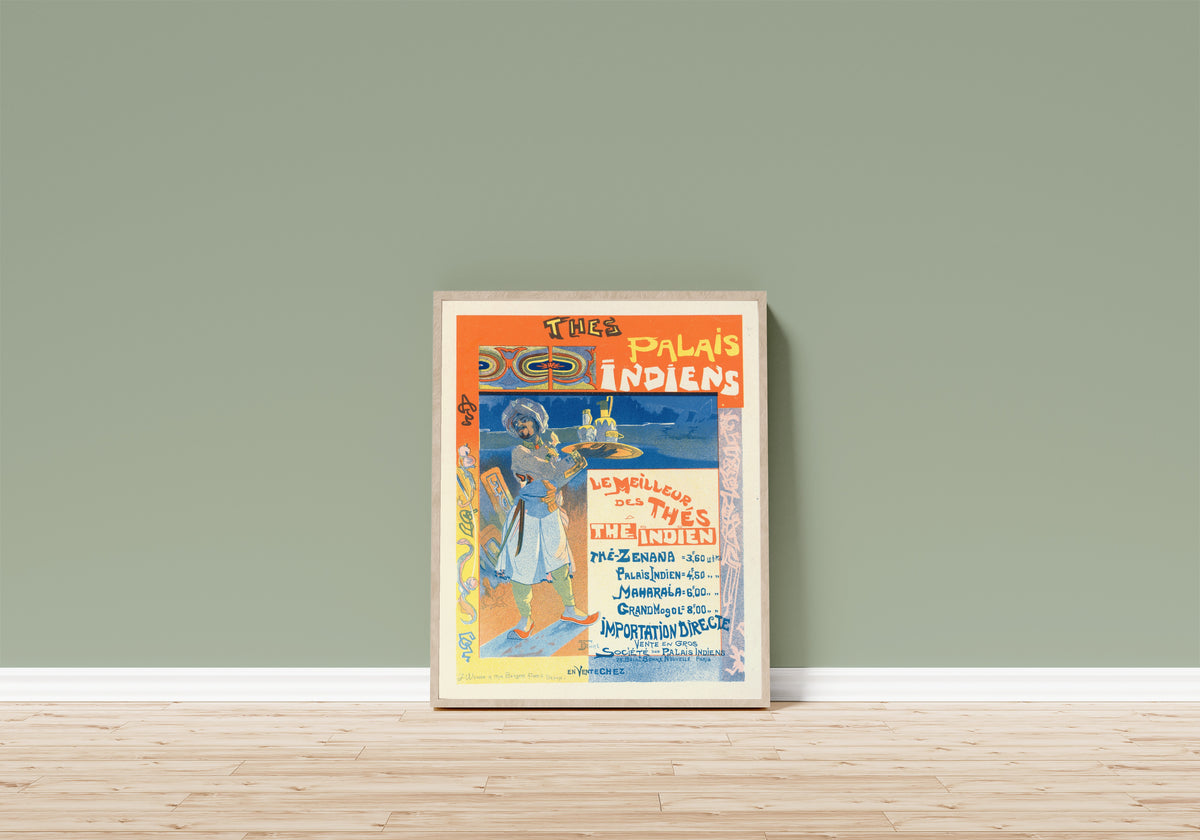 Framed art print of Thés du Palais Indien by Georges de Feure, in a light wood frame leaning on a sage green wall above a wooden floor