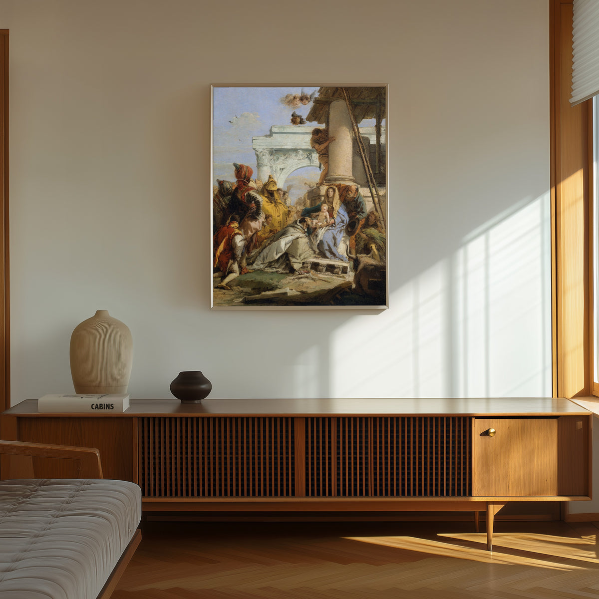 Framed art print of The Adoration of the Magi by Giovanni Battista Tiepolo, in a thin light frame on a sunlit wall above a wooden sideboard
