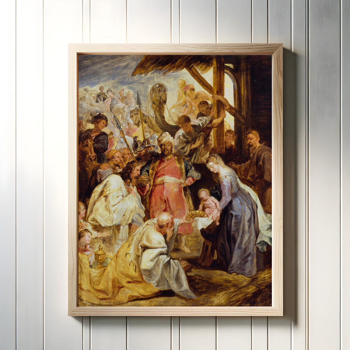 Framed art print of The Adoration of the Magi by Peter Paul Rubens, in a light wood frame on a white panelled wall