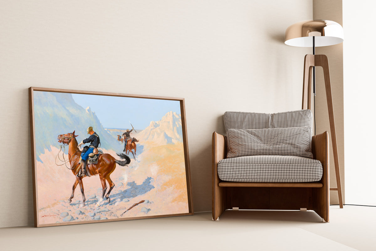 The Advance-Guard, or The Military Sacrifice by Frederic Remington — framed and leaning against a wall beside an armchair and a floor lamp