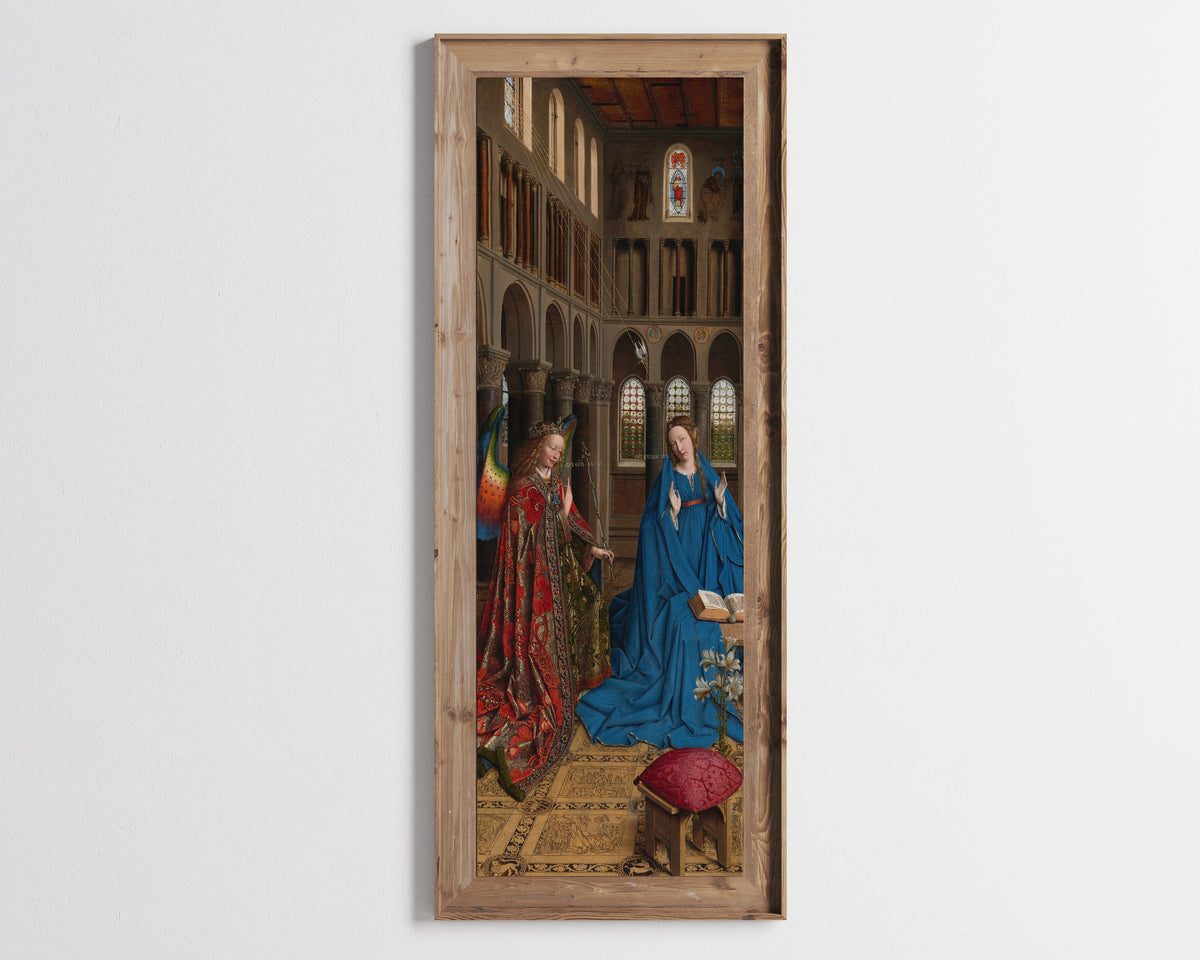 Framed art print of The Annunciation by Jan van Eyck, in a tall wooden frame on a pale wall