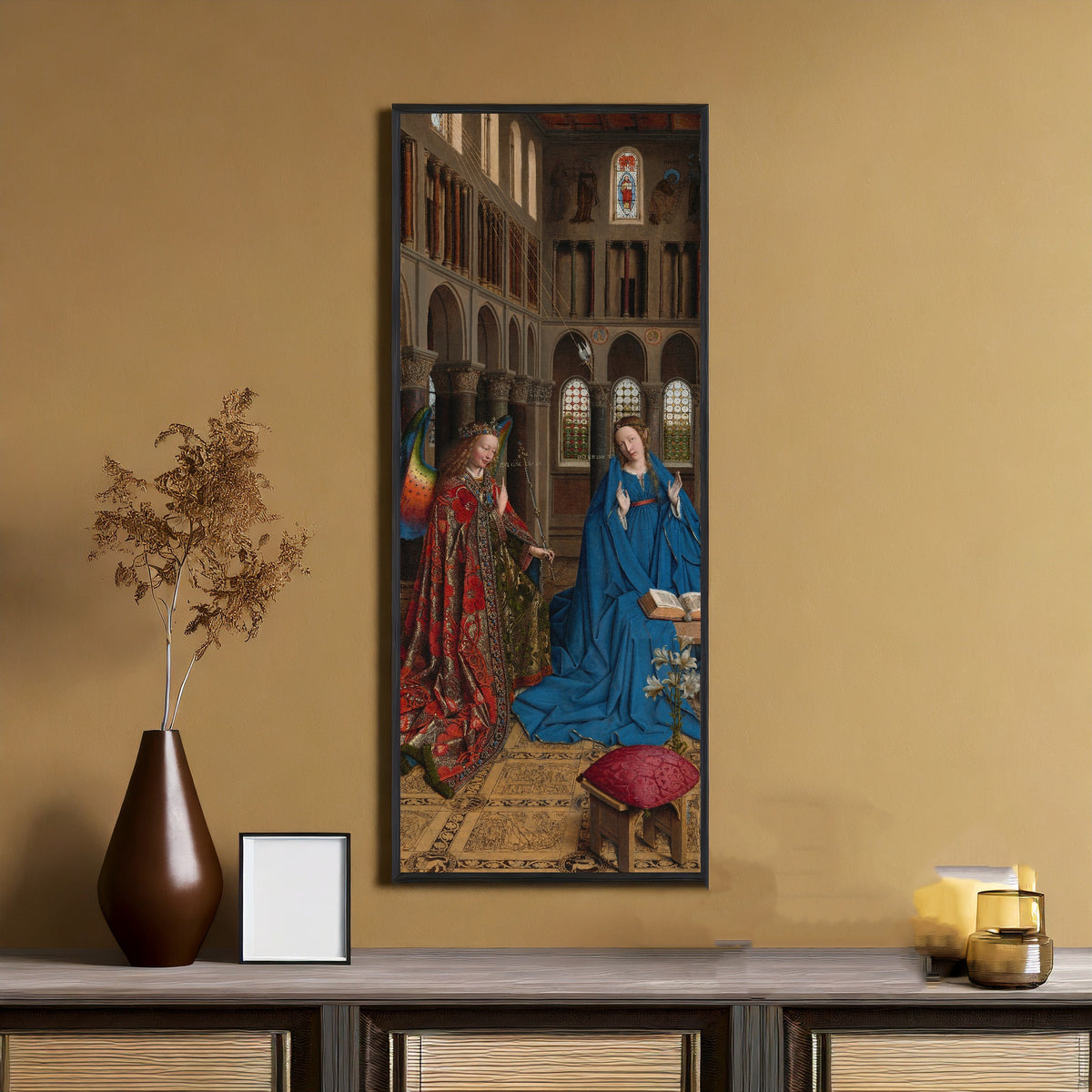 Framed art print of The Annunciation by Jan van Eyck, on an ochre wall above a console table