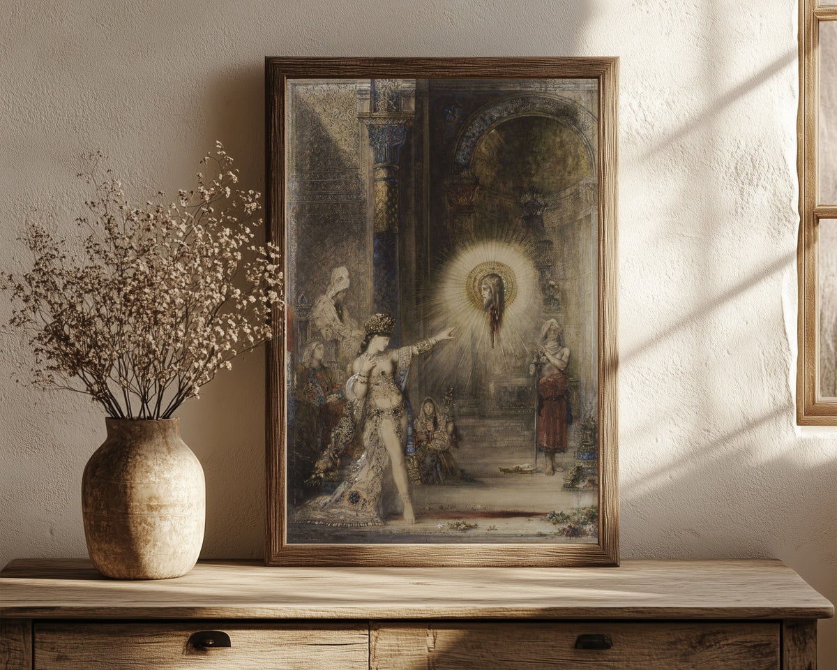 Framed art print of The Apparition by Gustave Moreau, in a dark wood frame leaning on a rustic console beside dried flowers