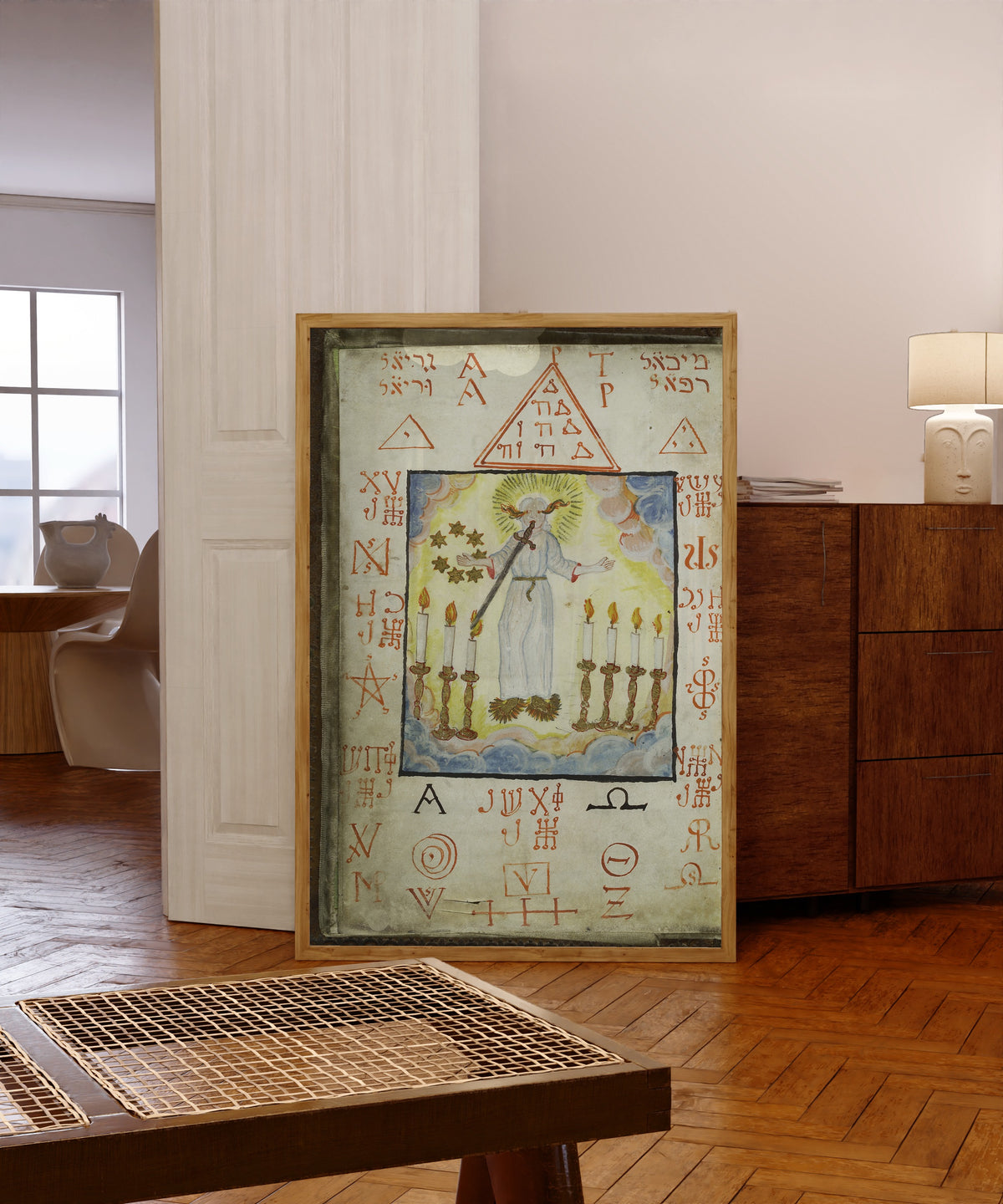 Framed art print of The Archangel Metraton, from Cyprianus by Unknown artist, in a light wood frame leaning in a warm room with a parquet floor