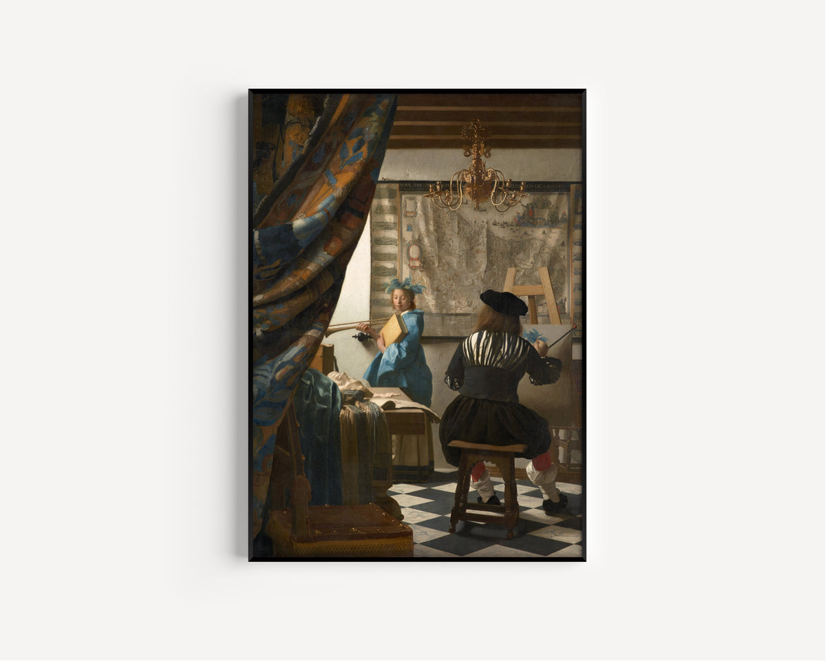 Framed art print of The Art of Painting by Johannes Vermeer, in a slim black frame on a plain white wall