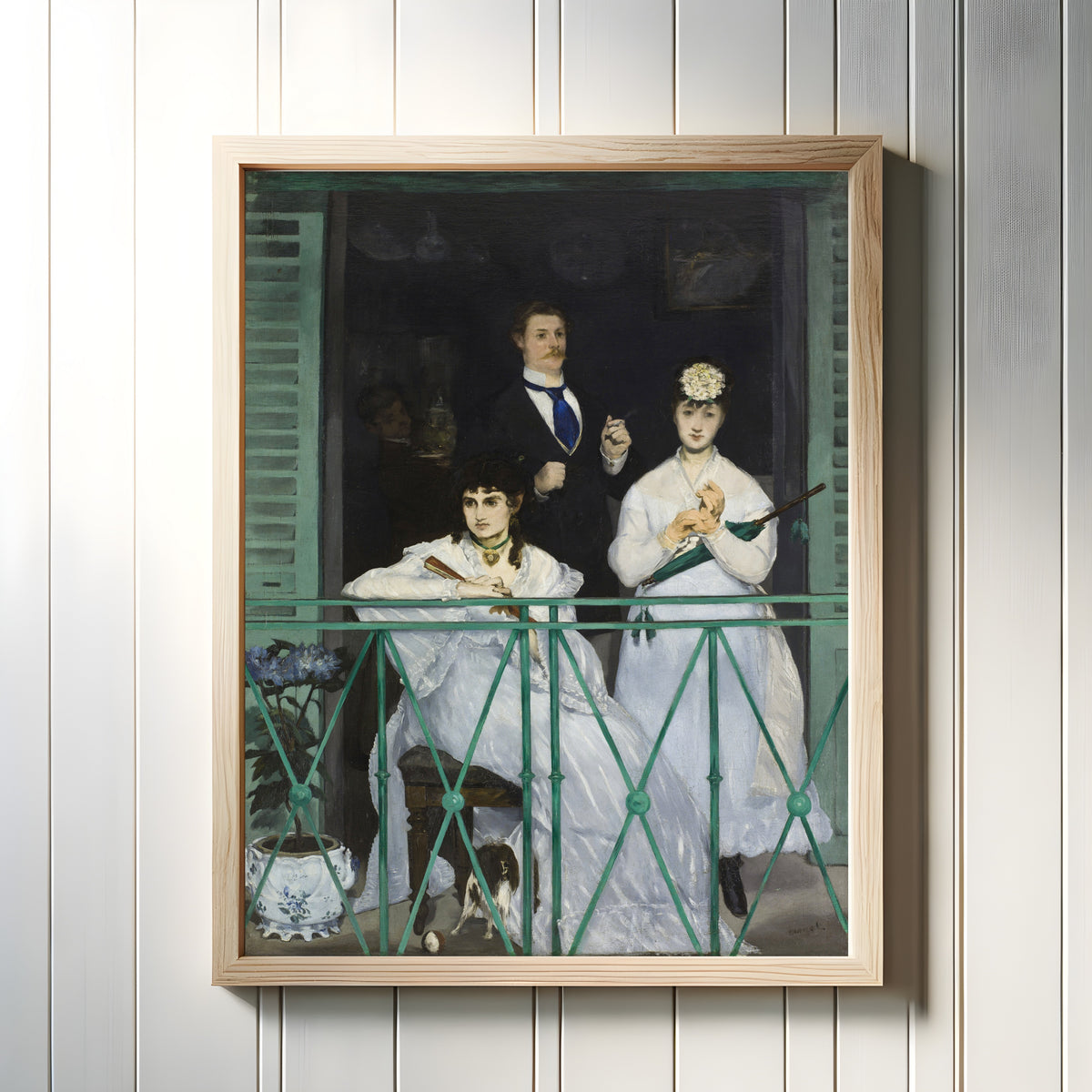 Framed art print of The Balcony by Édouard Manet, in a light wood frame on a white panelled wall