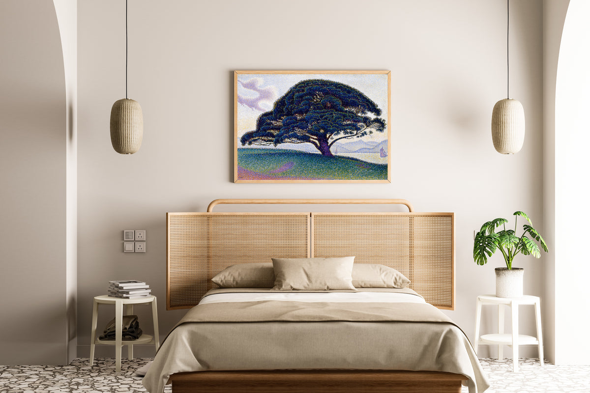 Framed art print of The Bonaventure Pine by Paul Signac, above a cane-headboard bed