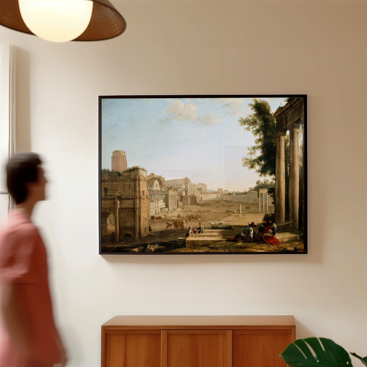 Framed art print of The Campo Vaccino, Rome by Claude Lorrain, in a slim black frame on a warm wall in a sunlit room