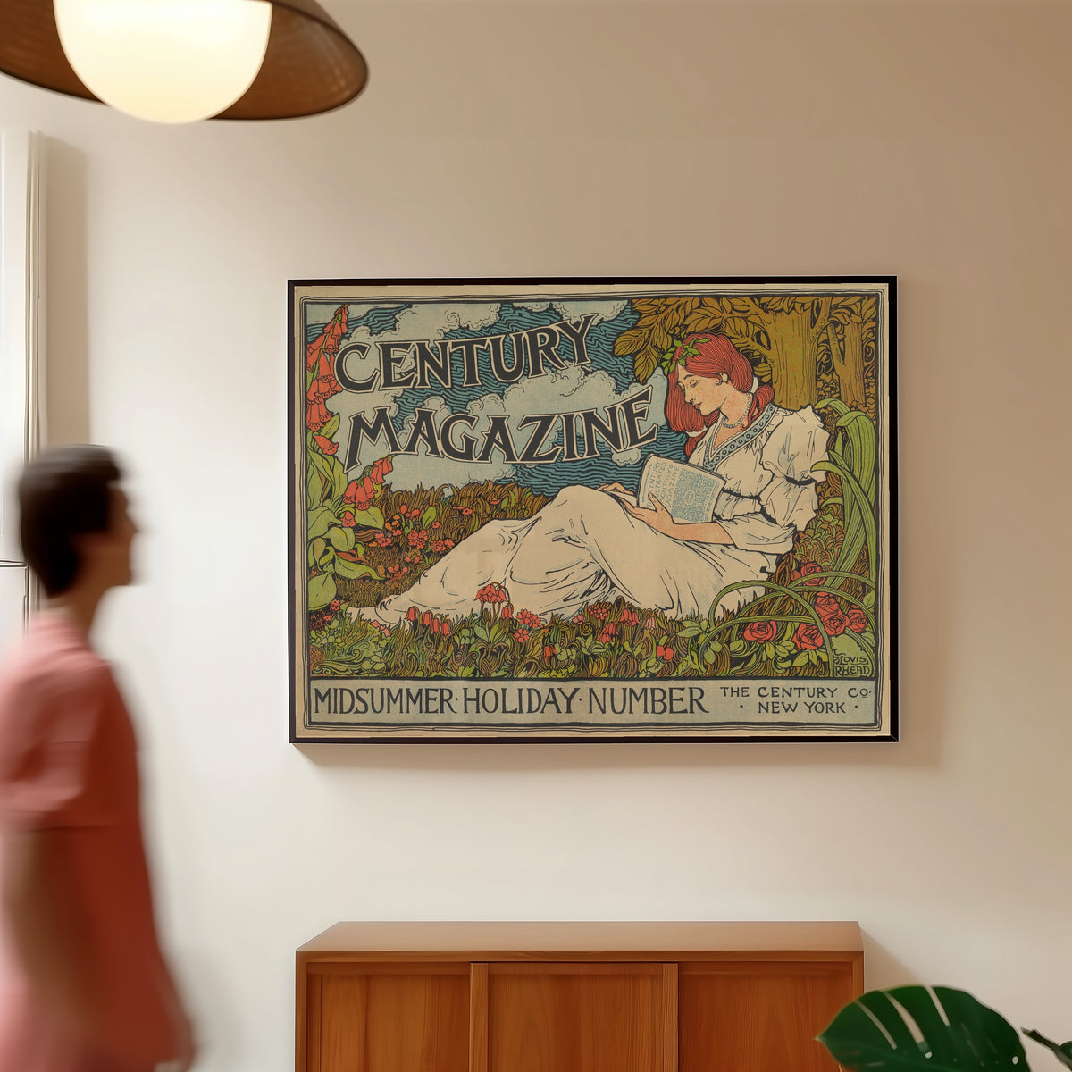 Framed art print of The Century Magazine, Midsummer Holiday Number by Louis Rhead, in a slim black frame on a warm wall in a sunlit room