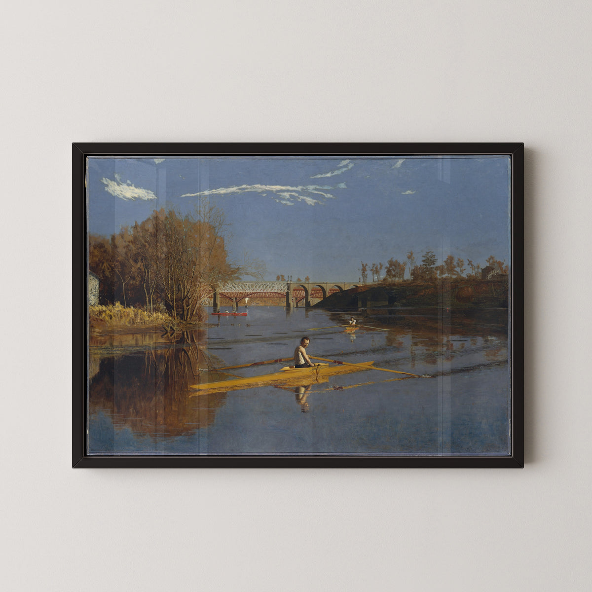 The Champion Single Sculls (Max Schmitt in a Single Scull) by Thomas Eakins — in a black frame on a pale wall