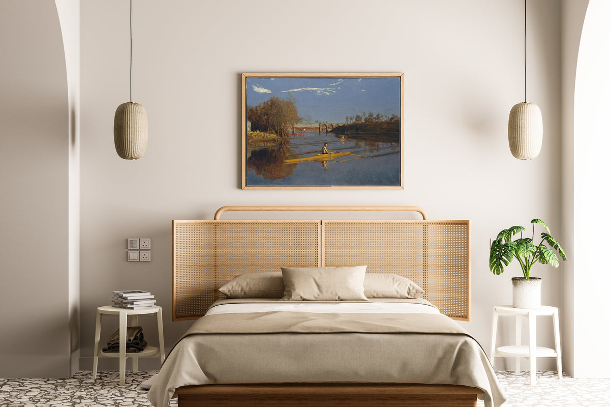 The Champion Single Sculls (Max Schmitt in a Single Scull) by Thomas Eakins — framed above a cane-headboard bed