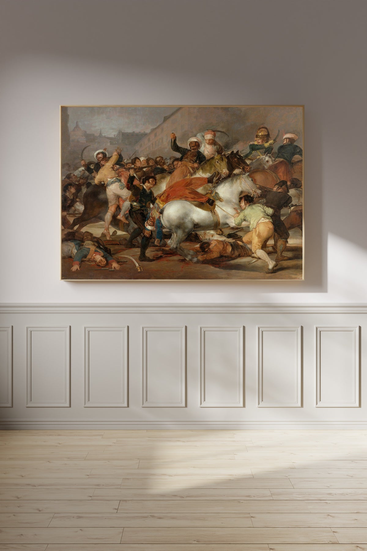 Framed art print of The Charge of the Mamelukes by Francisco de Goya, on a panelled wall in afternoon light
