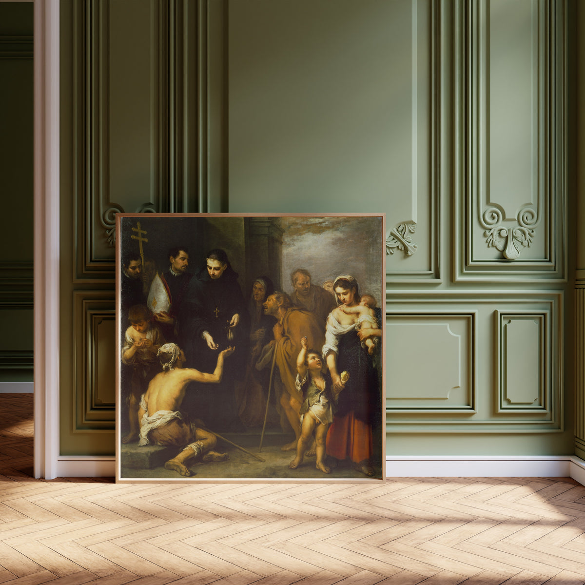 Framed art print of The Charity of Saint Thomas of Villanueva by Bartolomé Esteban Murillo, leaning against olive-green panelling on a herringbone floor