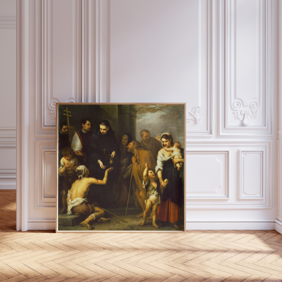 Framed art print of The Charity of Saint Thomas of Villanueva by Bartolomé Esteban Murillo, leaning against pale pink panelling on a herringbone floor