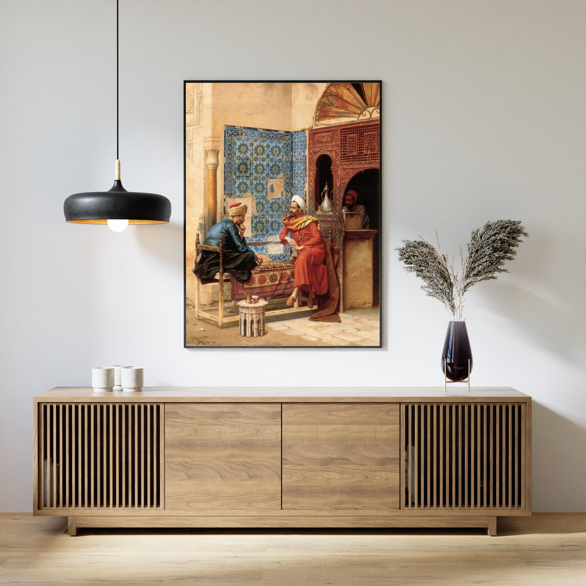Framed art print of The Chess Game by Ludwig Deutsch, above a slatted wood sideboard
