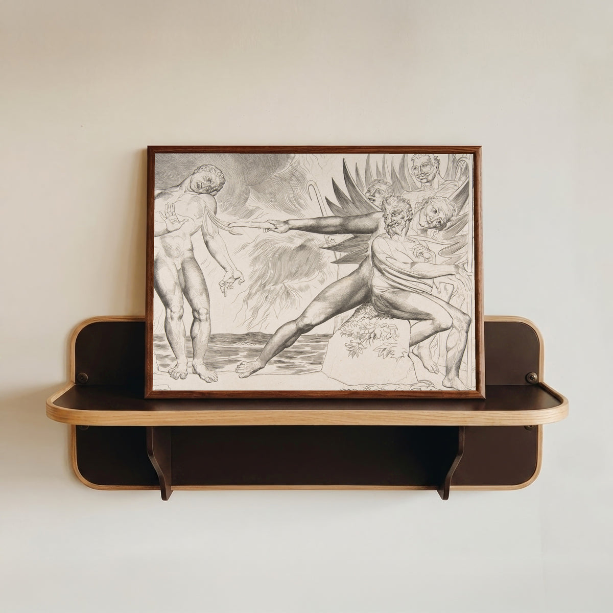 Framed art print of The Circle of Corrupt Officials: The Devils Tormenting Ciampolo by William Blake, in a dark wood frame resting on a wall shelf