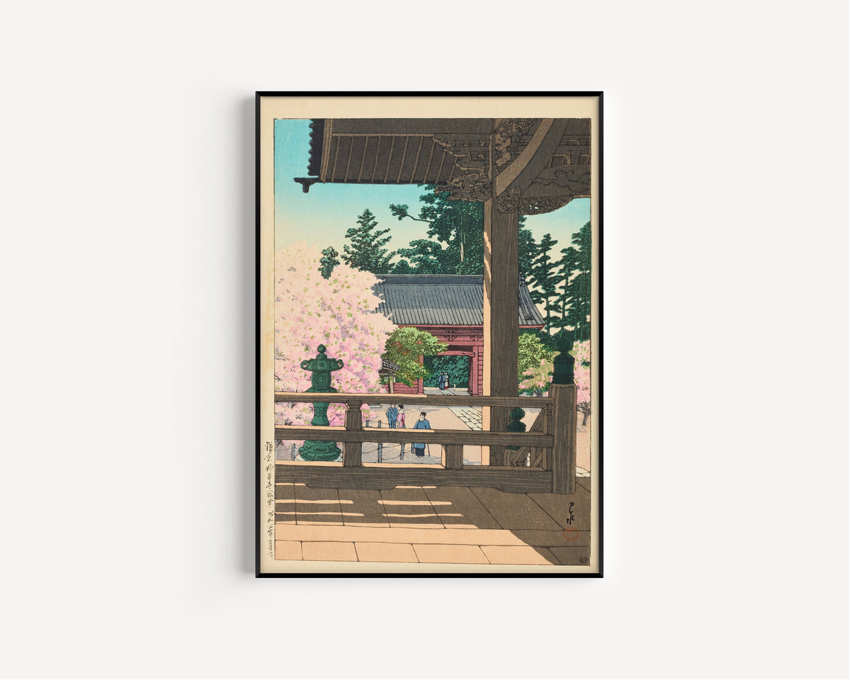 Framed art print of The Crabapple Flowers in Myohonji Temple, Kamakura by Kawase Hasui, in a slim black frame on a plain white wall