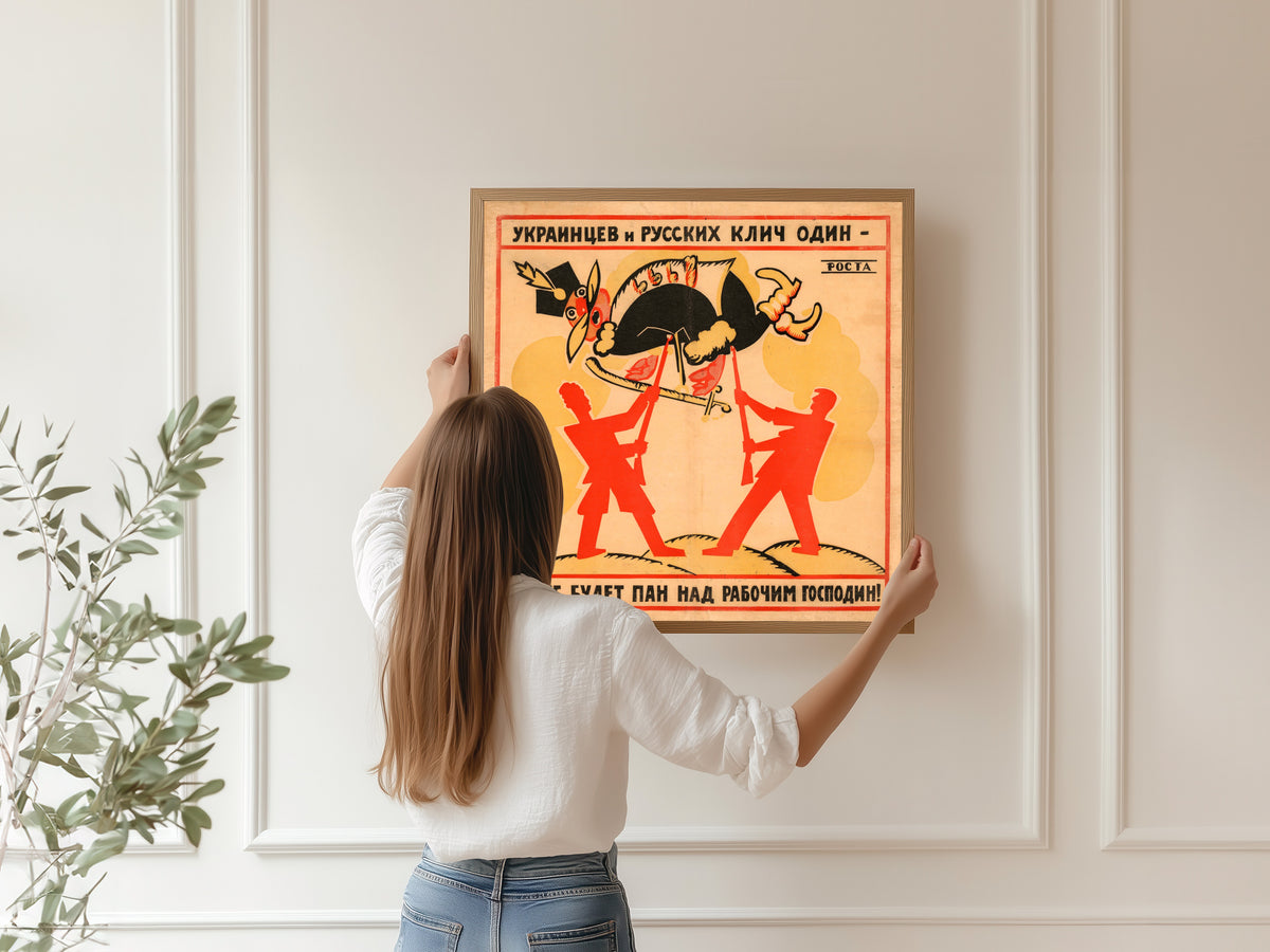Framed art print of The Cry of Ukrainians and Russians Is One: Let No Lord Be Master Over the Worker! by Vladimir Mayakovsky, hung on a panelled wall