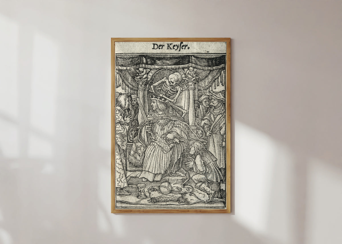 Framed art print of The Dance of Death: Der Keyser (The Emperor) by Hans Holbein the Younger, in a light wood frame on a sunlit white wall