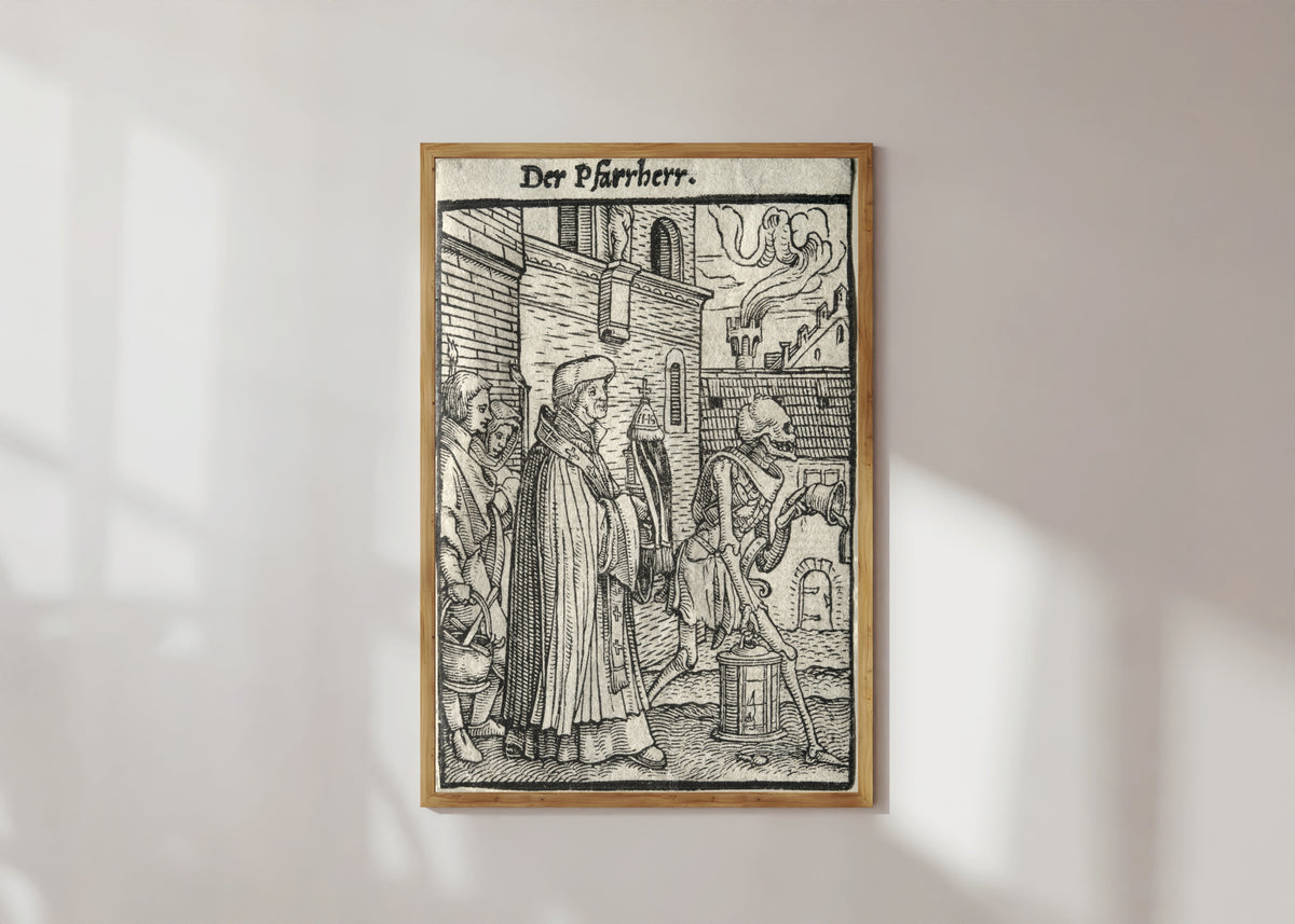 Framed art print of The Dance of Death: Der Pfarrherr (The Pastor) by Hans Holbein the Younger, in a light wood frame on a sunlit white wall