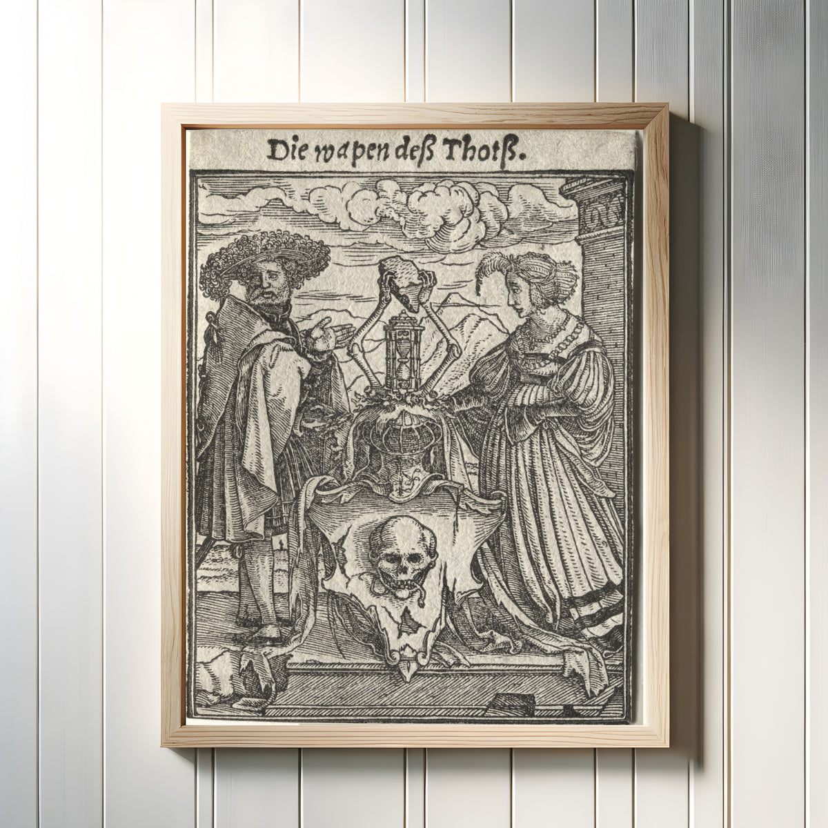 Framed art print of The Dance of Death: Die wapen deß Thotß (The Coat of Arms of… by Hans Holbein the Younger, in a light wood frame on a white panelled wall