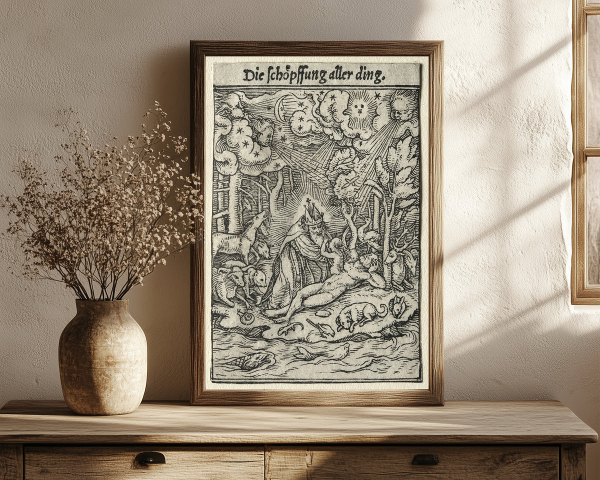 Framed art print of The Dance of Death: The Creation by Hans Holbein the Younger, in a dark wood frame leaning on a rustic console beside dried flowers