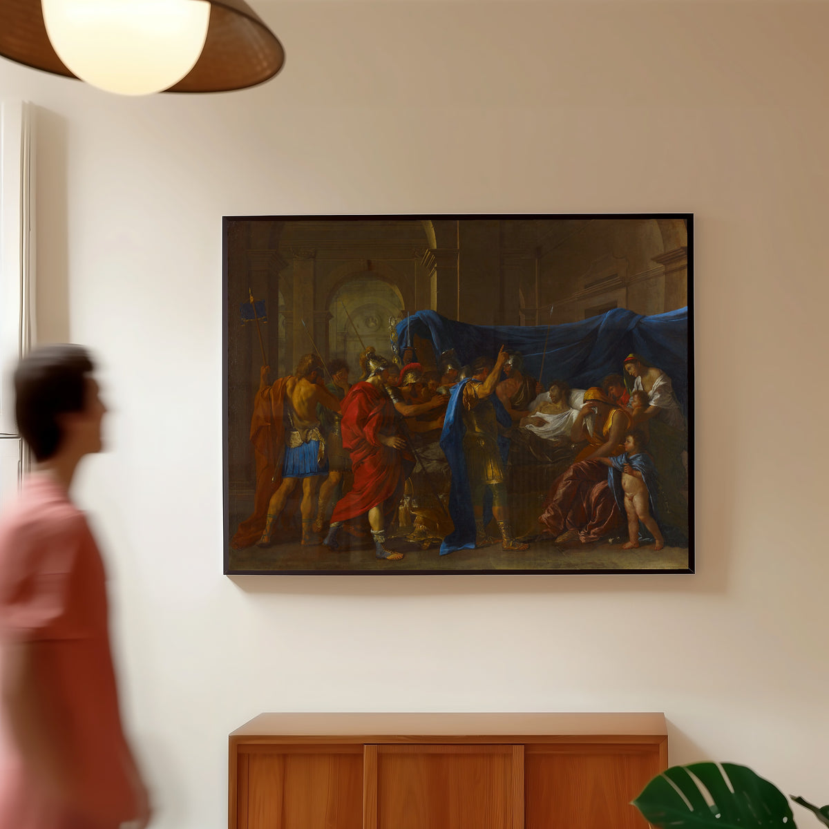 Framed art print of The Death of Germanicus by Nicolas Poussin, in a slim black frame on a warm wall in a sunlit room
