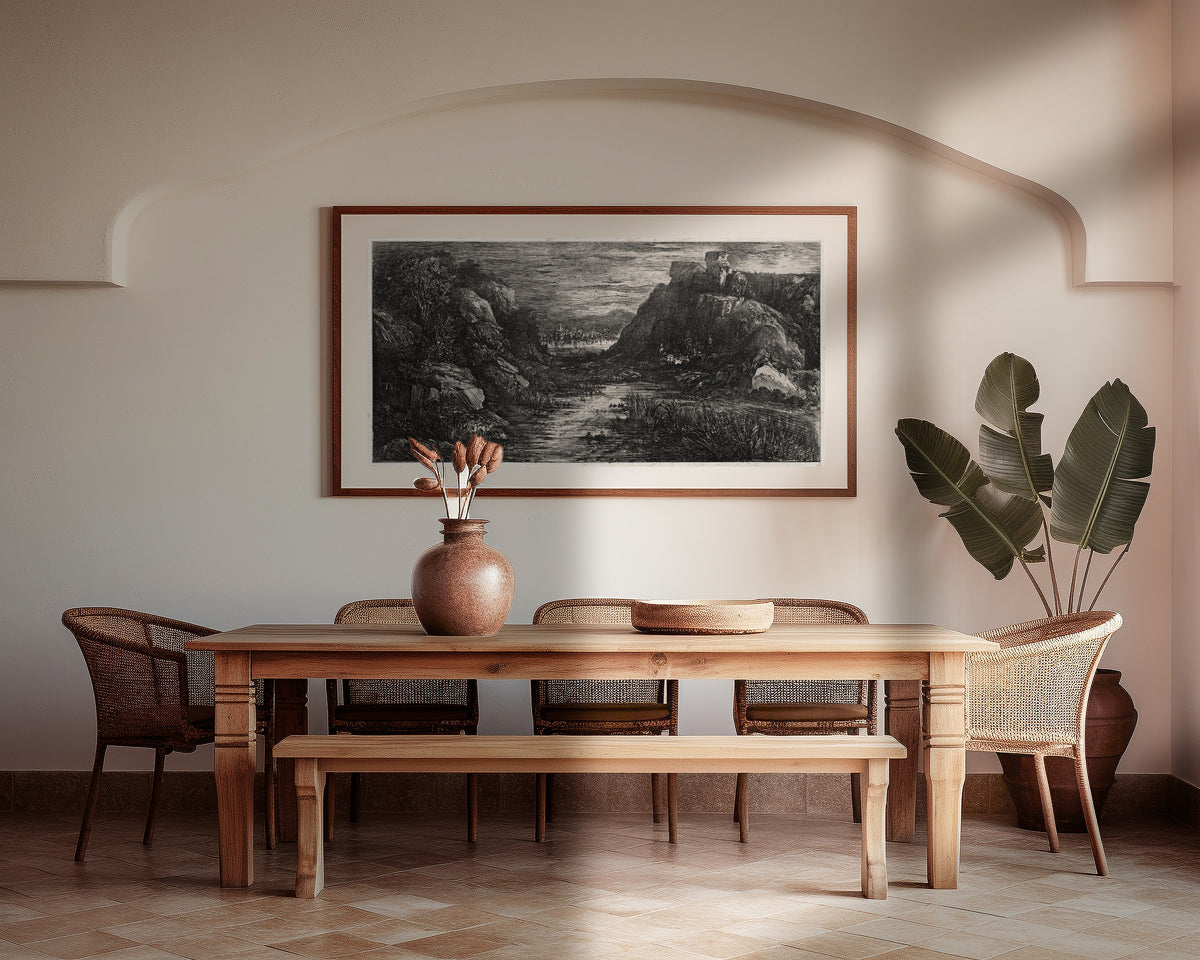 Framed art print of The Distant City by Rodolphe Bresdin, above a wooden dining table