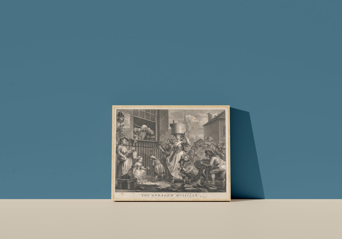 Framed art print of The Enraged Musician by William Hogarth, in a light wood frame leaning on a blue wall