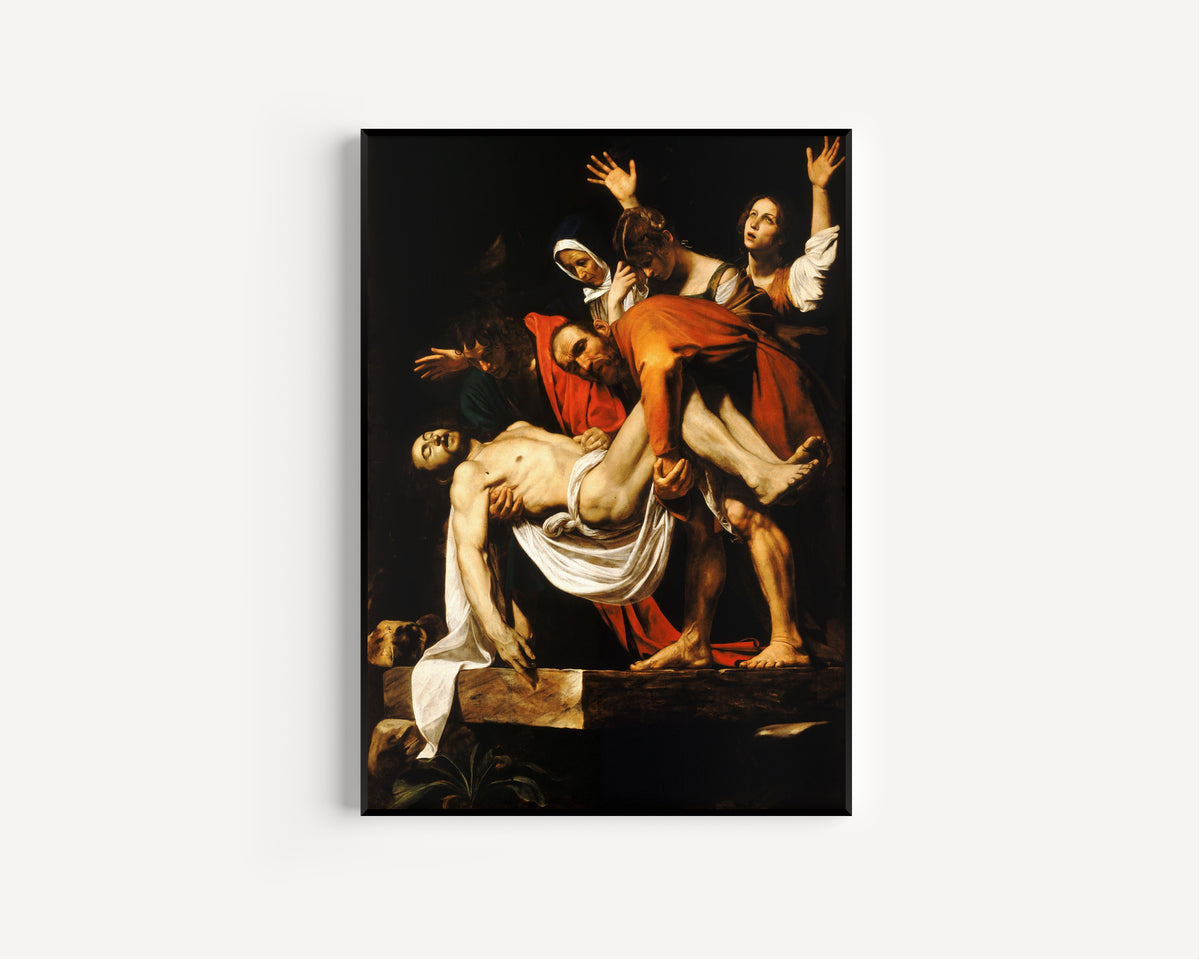 Framed art print of The Entombment of Christ by Caravaggio, in a slim black frame on a plain white wall