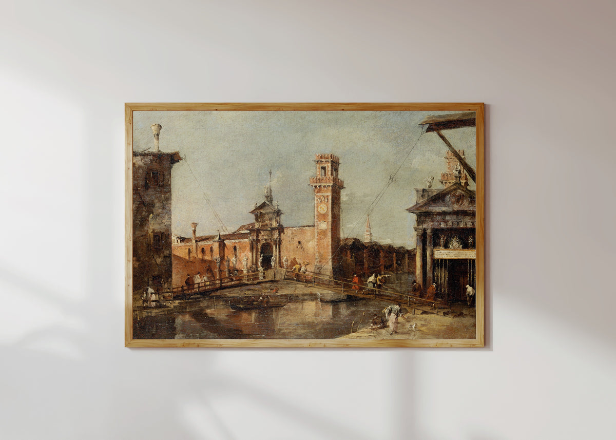 Framed art print of The Entrance to the Arsenal in Venice by Francesco Guardi, in a light wood frame on a sunlit white wall