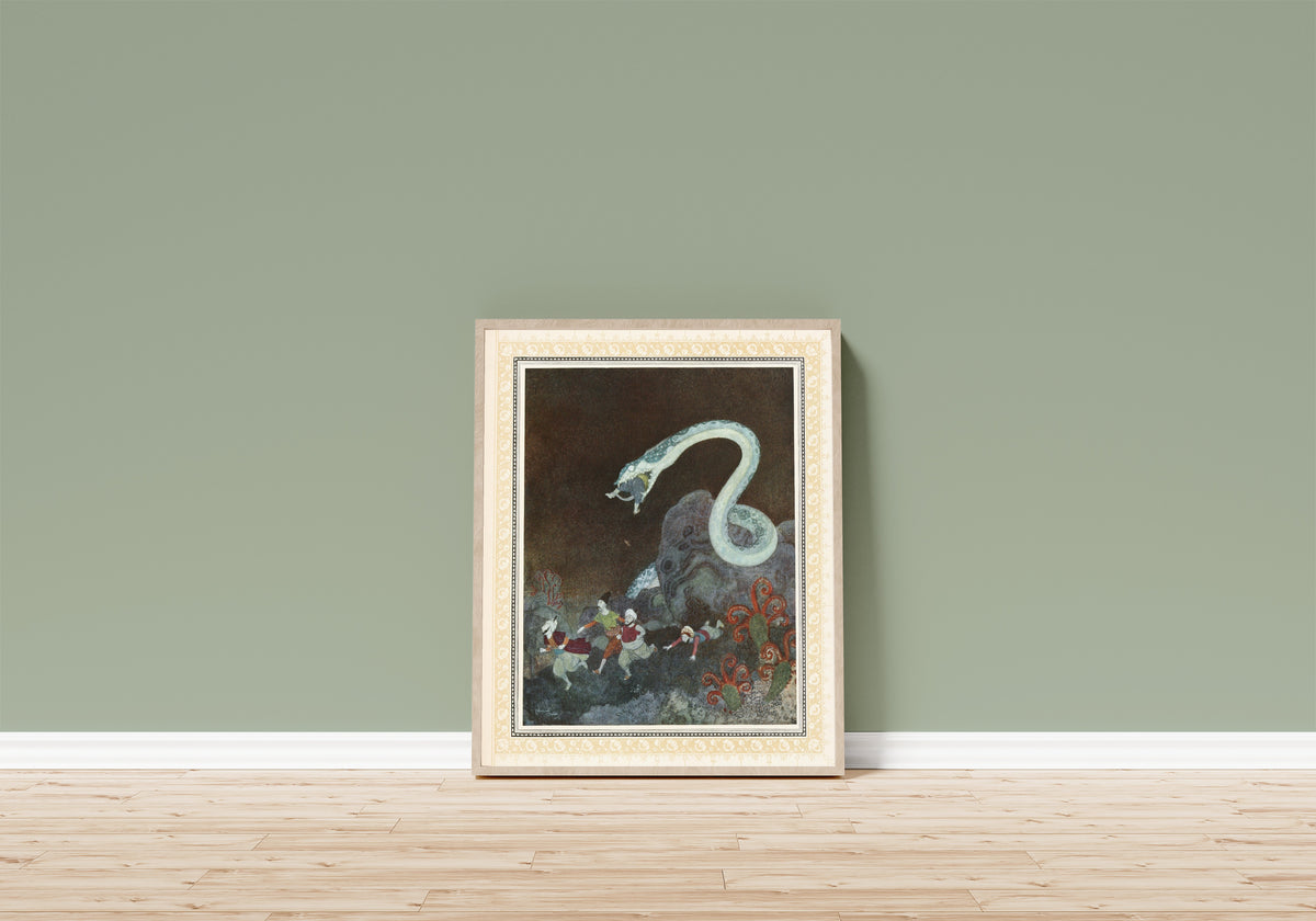 Framed art print of The Episode of the Snake by Edmund Dulac, in a light wood frame leaning on a sage green wall above a wooden floor