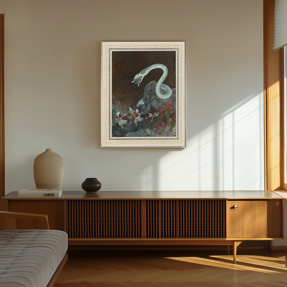 Framed art print of The Episode of the Snake by Edmund Dulac, in a thin light frame on a sunlit wall above a wooden sideboard