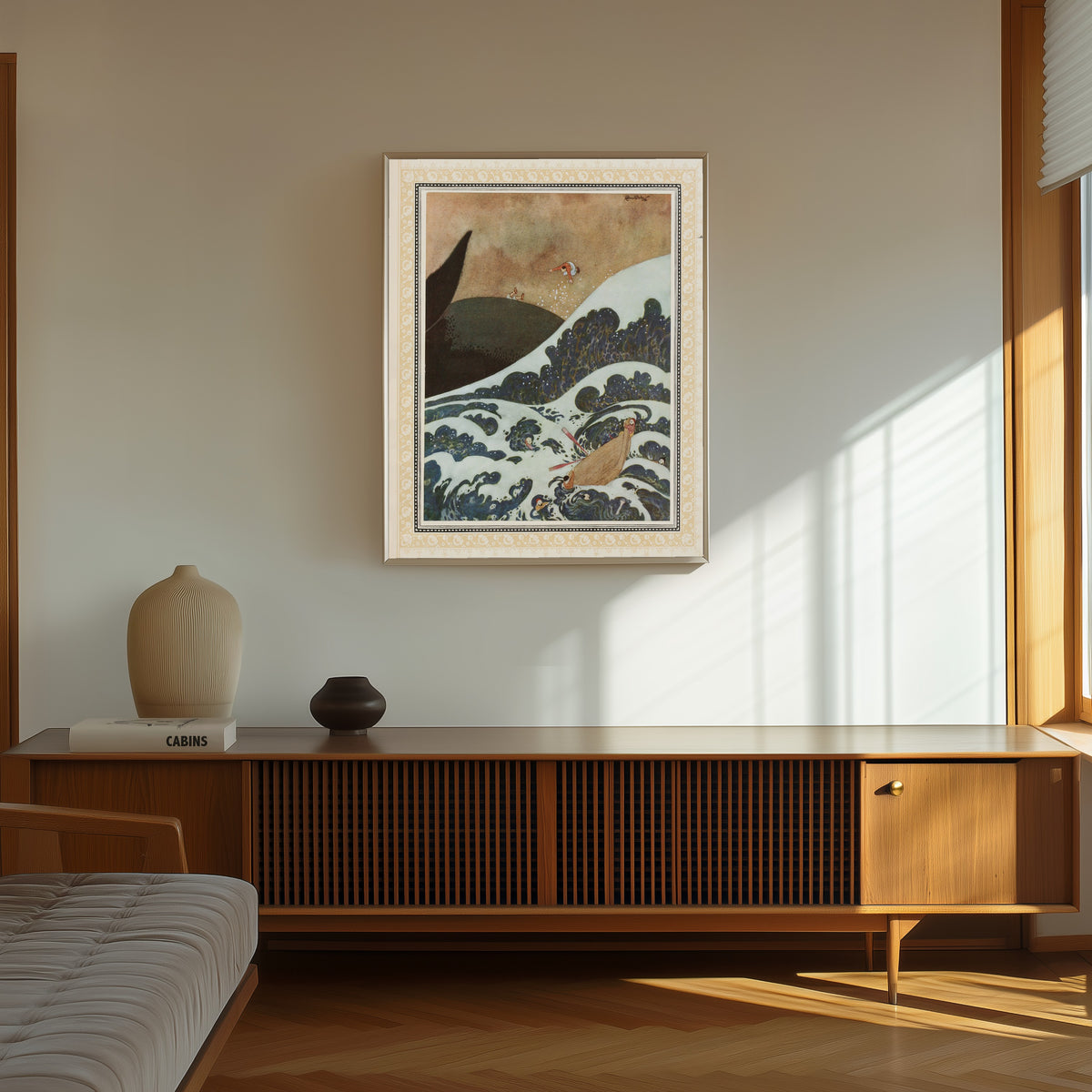 Framed art print of The Episode of the Whale by Edmund Dulac, in a thin light frame on a sunlit wall above a wooden sideboard