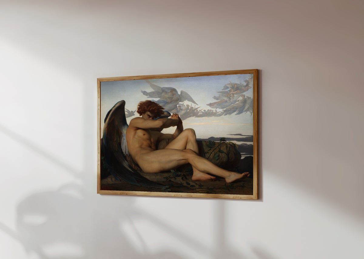 Framed art print of The Fallen Angel by Alexandre Cabanel, in a light wood frame on a sunlit white wall, seen at a slight angle