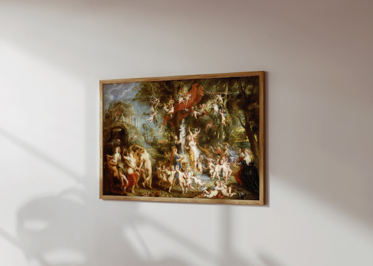 Framed art print of The Feast of Venus by Peter Paul Rubens, in a light wood frame on a sunlit white wall, seen at a slight angle