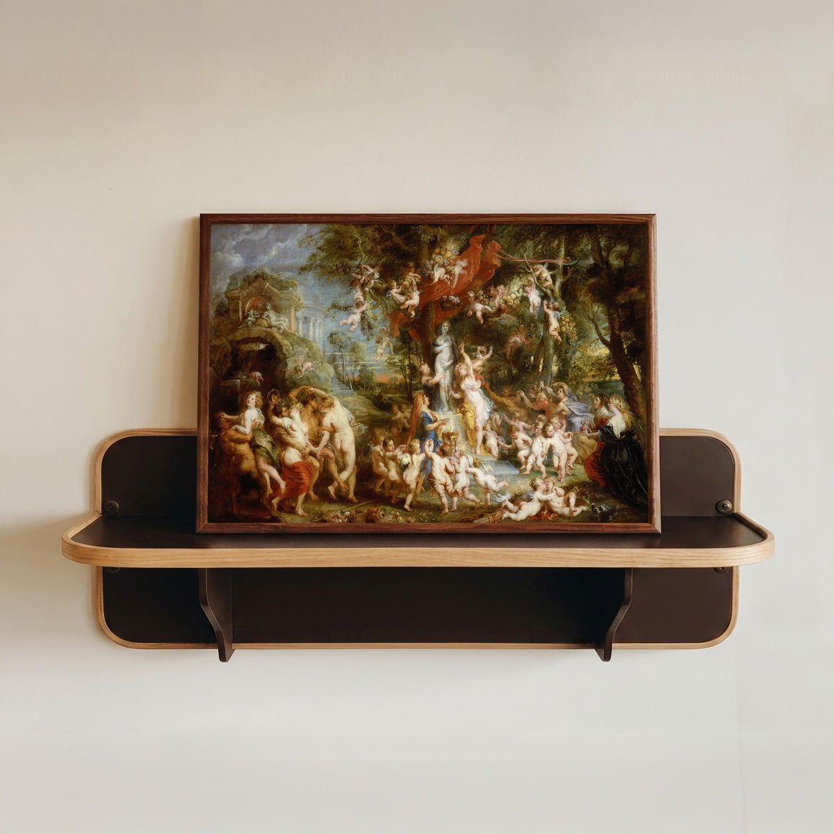 Framed art print of The Feast of Venus by Peter Paul Rubens, in a dark wood frame resting on a wall shelf